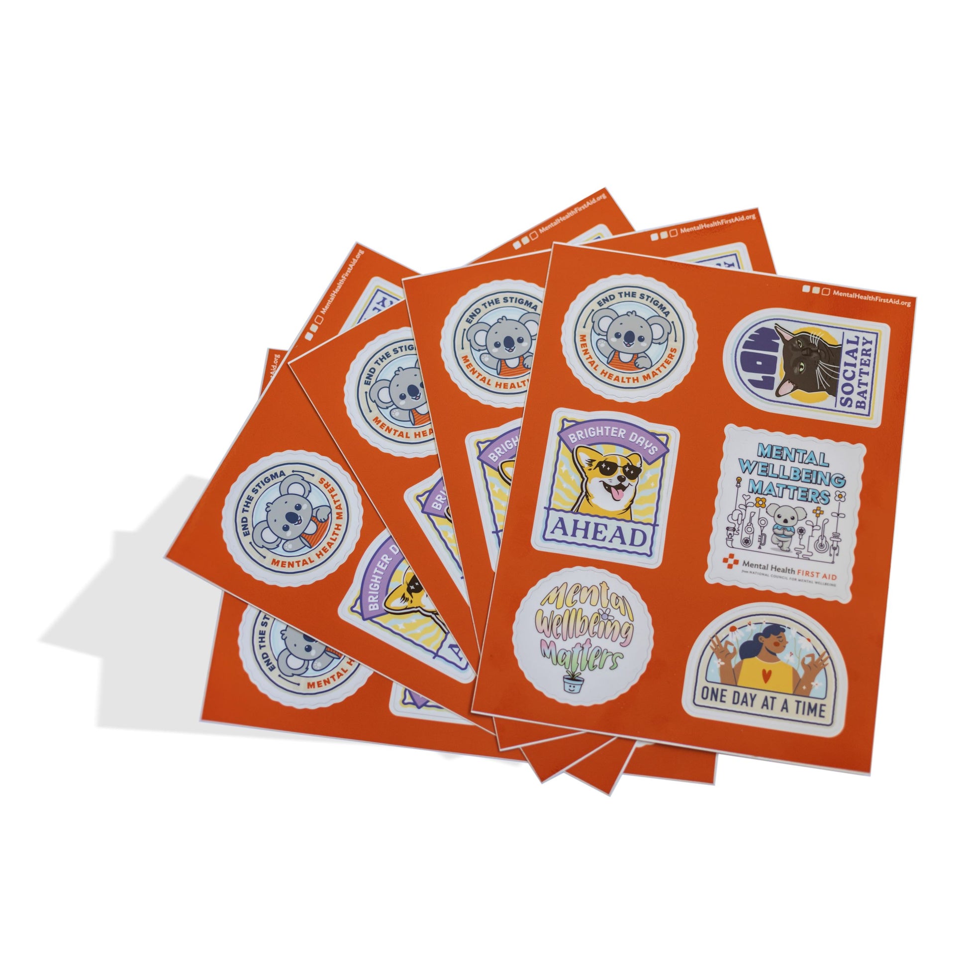 Stack of orange sticker sheets with various printed designs on a white background
