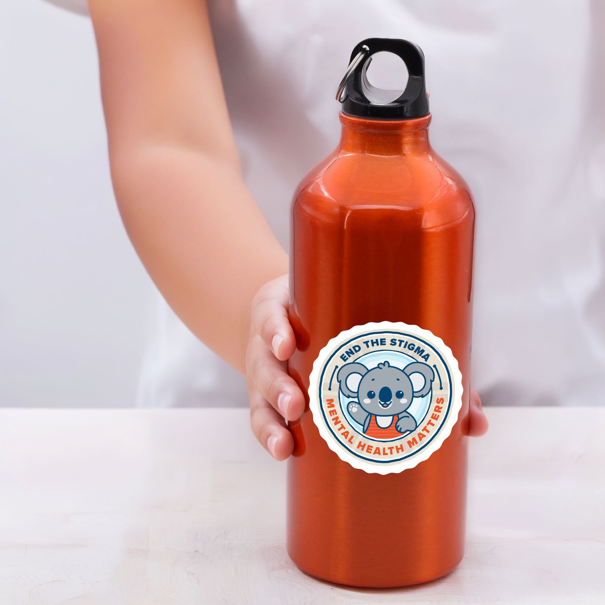 Orange water bottle with a logo featuring a koala and text on a white background